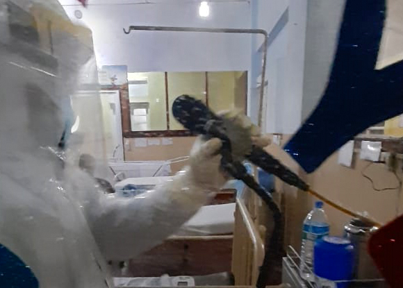 An airman sanitizes indoor shooting stations.