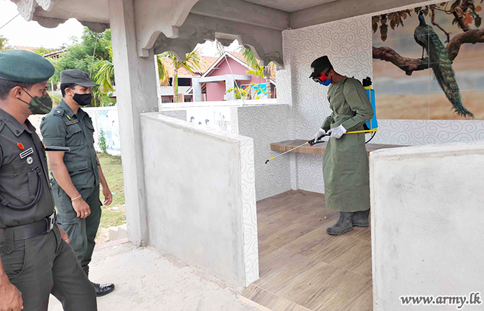 An airman sanitizes indoor shooting stations.