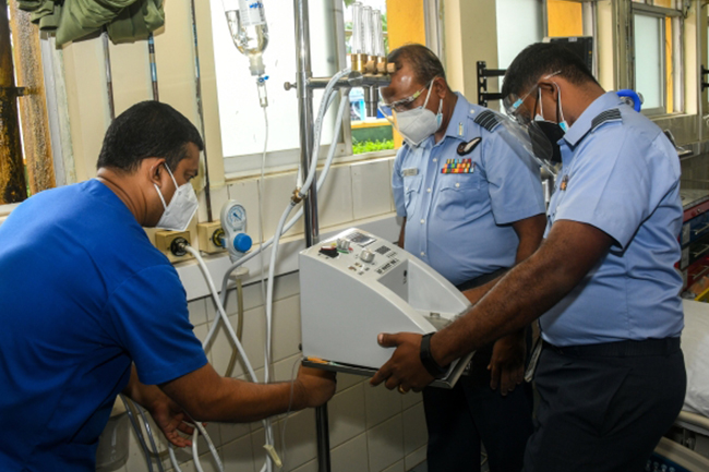 An airman sanitizes indoor shooting stations.