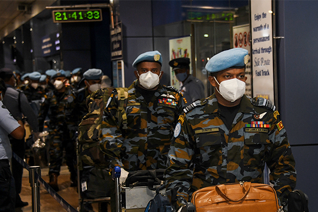 An airman sanitizes indoor shooting stations.