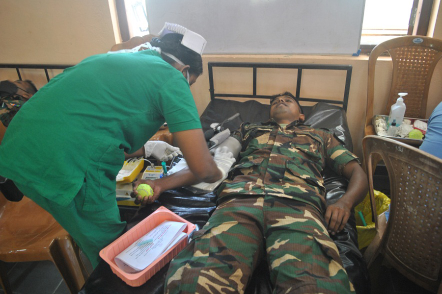 An airman sanitizes indoor shooting stations.