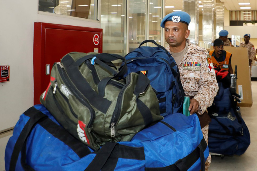 An airman sanitizes indoor shooting stations.