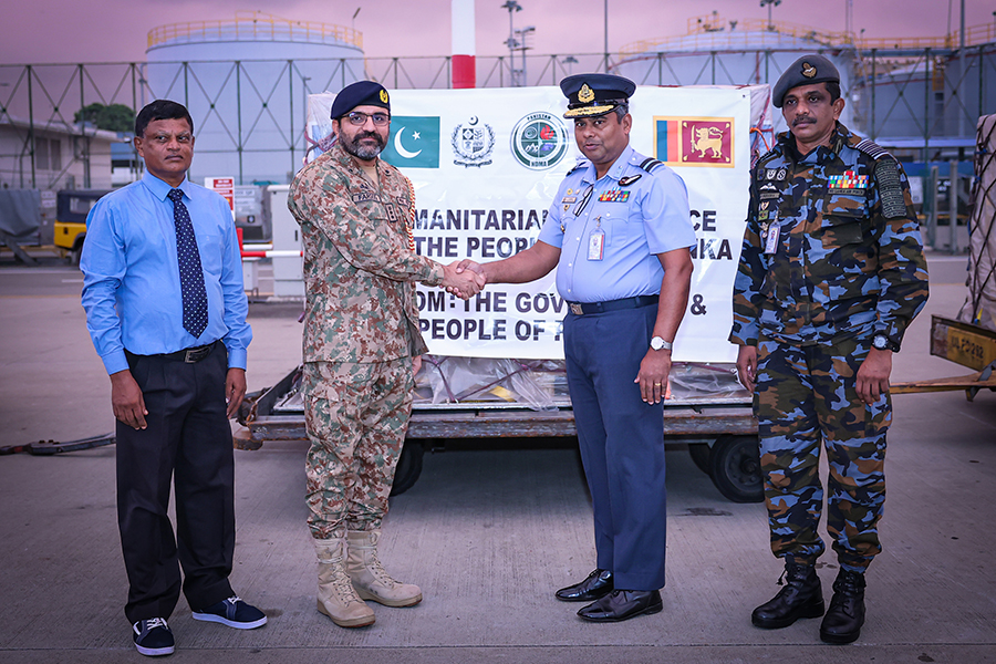 An airman sanitizes indoor shooting stations.